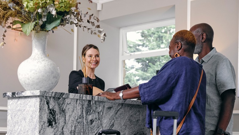 Hotel receptionist greets guests